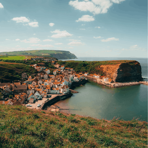 Explore Staithes' clifftop paths and cobbled streets, a three-minute drive away