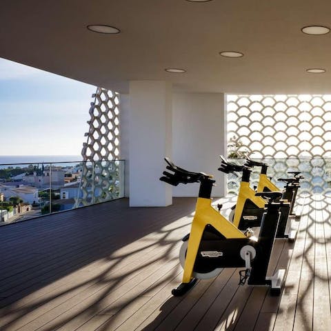 Keep on top of your fitness routine at the on-site gym with a sea view