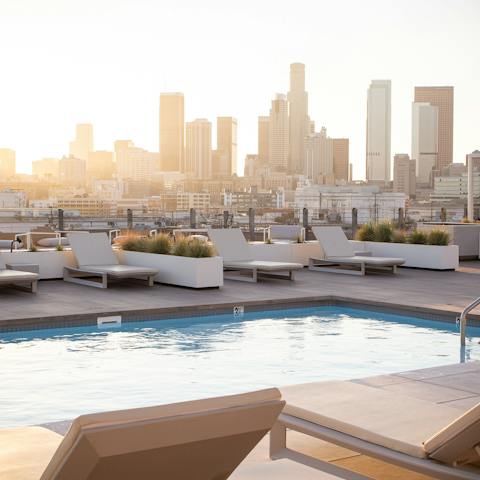 Admire the impressive LA skyline from the shared rooftop swimming pool