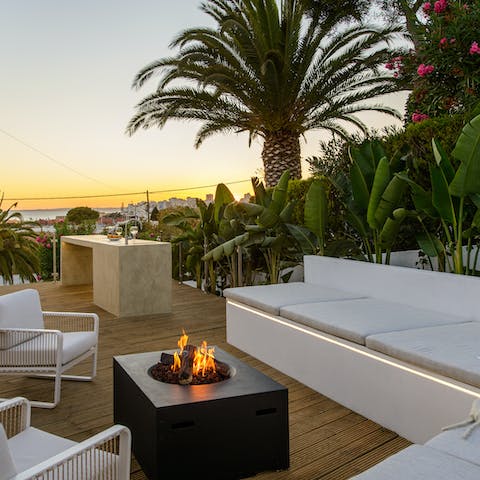 Open a bottle of wine and keep warm by the fire pit as the sun sets into the Atlantic Ocean