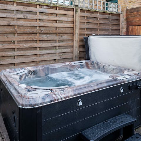 Soak in the bubbling hot tub on the back terrace