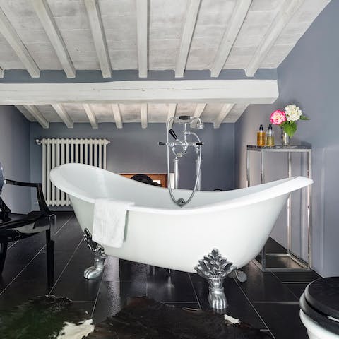 Sink into the hot waters of the elegant standalone bathtub