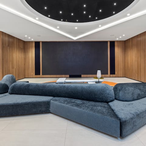 Watch a film in the home cinema room