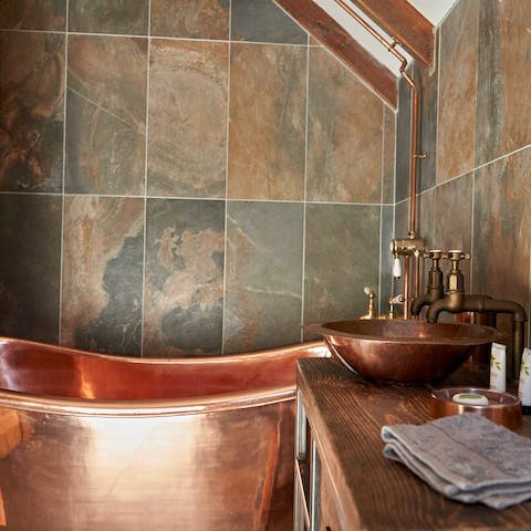 Enjoy a long soak in the copper bathtub