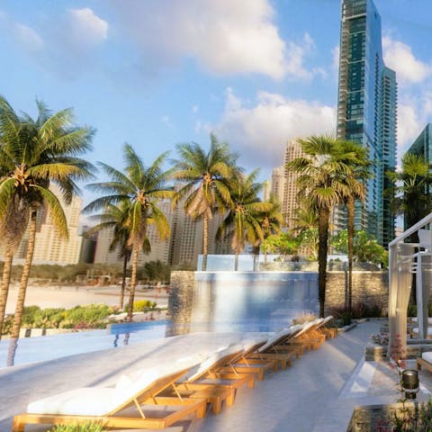 Soak up some rays by the palm-fringed communal pool