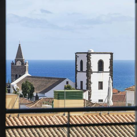 Wake up to an impressive view of the Cathedral of Funchal and the glistening sea