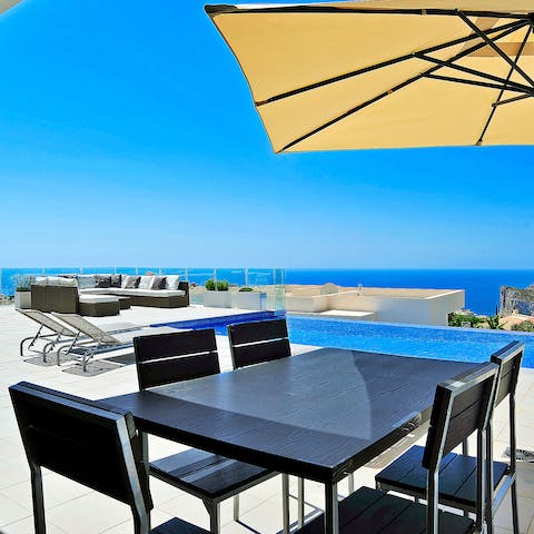 Enjoy alfresco meals by the sparkling swimming pool
