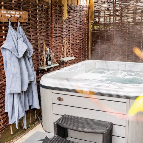 Soak away the evening in the hot tub cocooned by twinkly lights – there's fluffy hooded robes at the ready