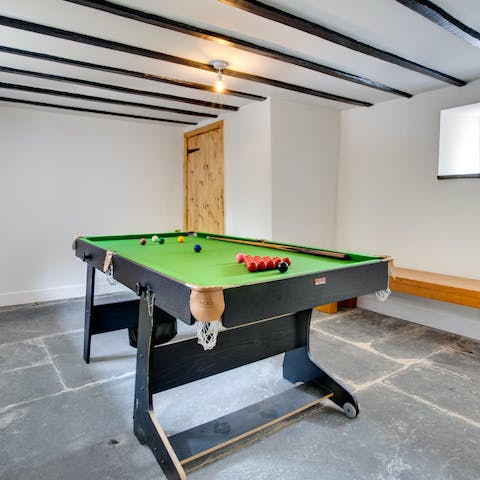 Kick back in the games room with your own pool table