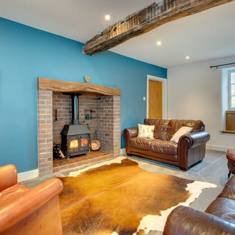 Warm up by the log burner in your cosy living room
