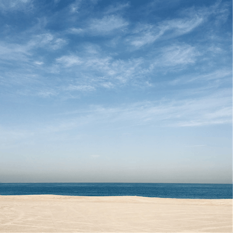 Enjoy a sandy stroll as you head to Mina Seyahi Beach, just one–minute away