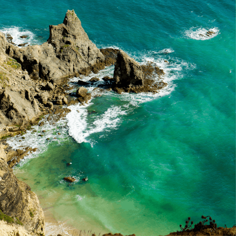 Explore Praia da Luz's sandy beach and rocky coastline, a three-minute stroll away