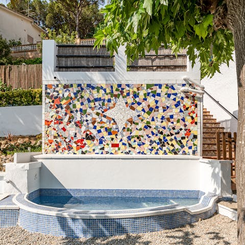 Cool off in the plunge pool as you admire the intricate mosaic on the wall