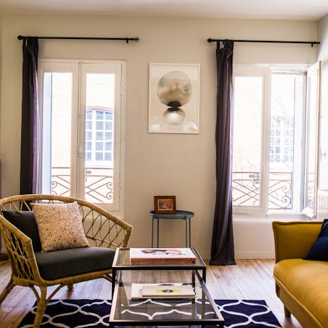 Relax in the stylish living area besides the Parisian windows
