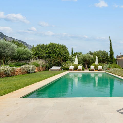 Cool off in the swimming pool, surrounded by greenery and hills