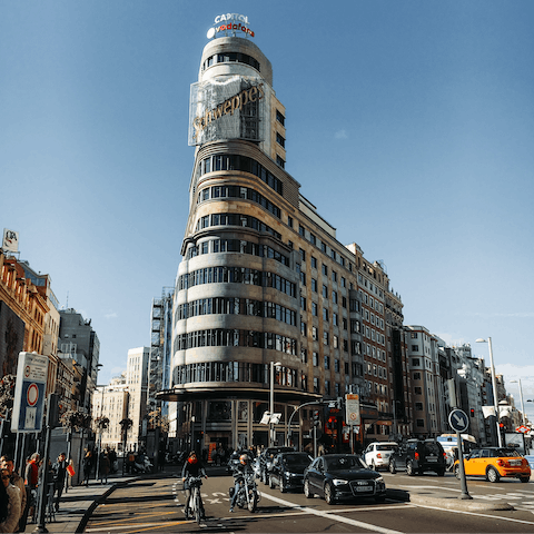 Admire Gran Vía's impressive architecture, an eighteen-minute walk away