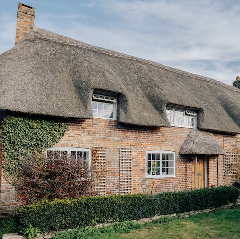 Stay in a charming cottage with a traditional thatched roof