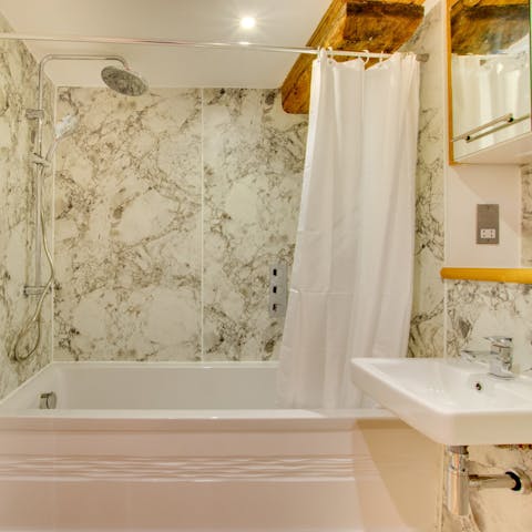 Freshen up in marble-tiled bathrooms