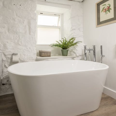 Unwind in the huge free standing bath tub after a day amidst the fresh sea air 