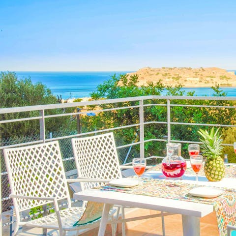 Sip fresh juice on the balcony overlooking the sparkling Aegean