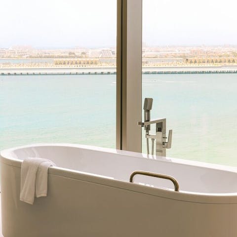 Enjoy a bird's-eye-view over the ocean and surrounding area from the freestanding bathtub