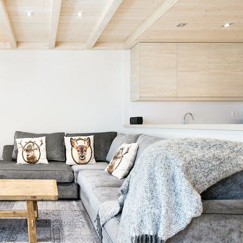 Get cosy on the snug L-shaped sofa, with the soft throws and crackling fireplace keeping you warm