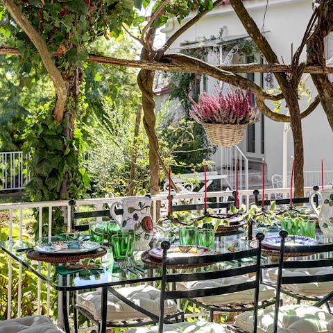 Dine alfresco under the dappled shade of the vines