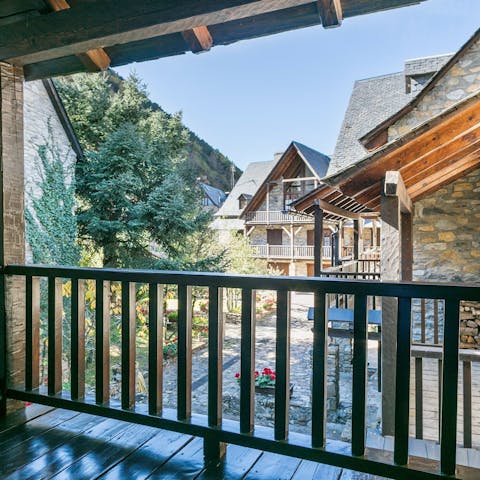 Admire the quaint village set against the mountains from your balcony