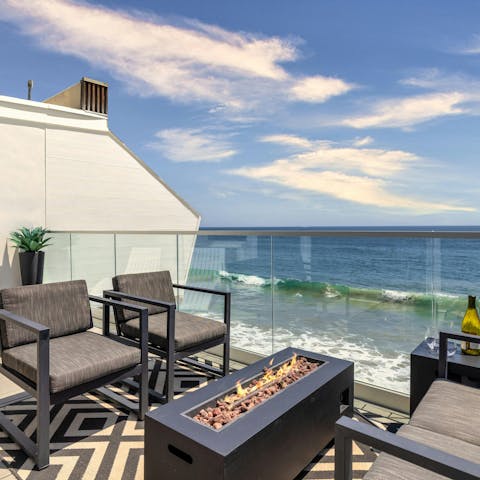 Light the fire pit and watch the sunset over the Pacific Ocean