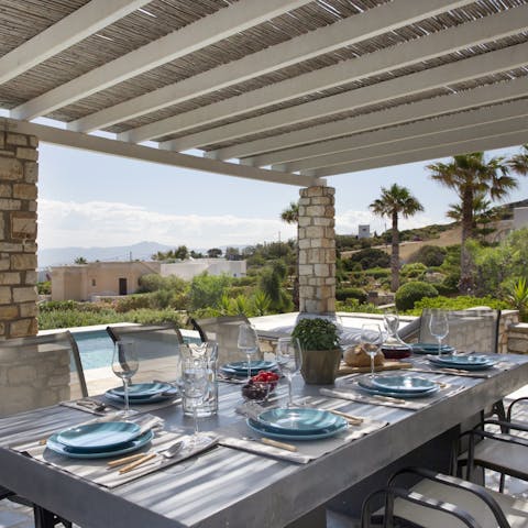 Share traditional Greek dishes around the outside dining table