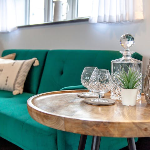Kick back with a gin on the bold green sofa