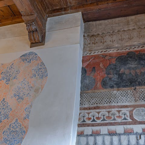 Inspect and admire the antique frescoes on the wall