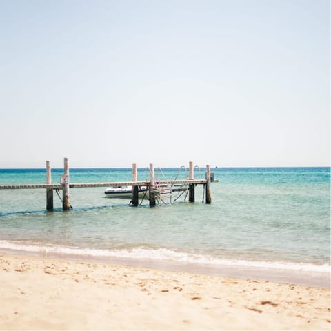 Walk 400m to a sandy beach for a day of paddling and sunbathing