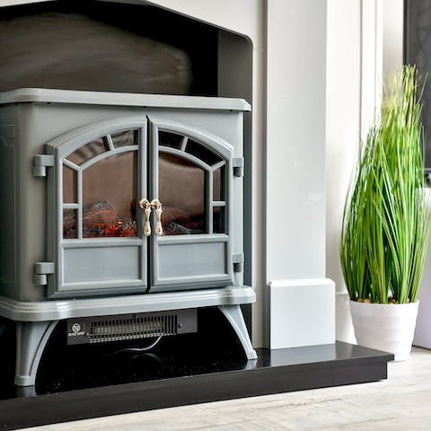 Get cosy by the electric fireplace on chilly winter evenings
