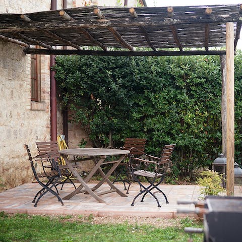 Enjoy a cup of coffee in the shade of the wooden pergola