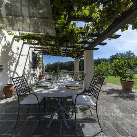 Get together under the vine-covered pergola to enjoy a meal alfresco 