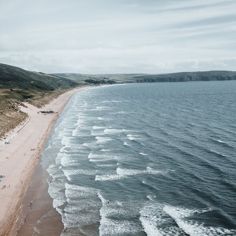 Take your pick of paddleboarding or surfing on the waves of Woolacombe Beach