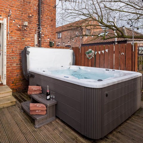 Sip a glass of fizz from the bubbles of your private hot tub