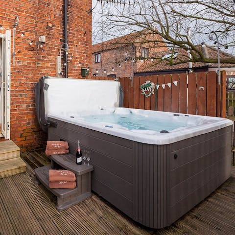 Sip a glass of fizz from the bubbles of your private hot tub