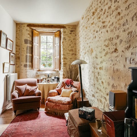 This quirky shaped room with original stone walls
