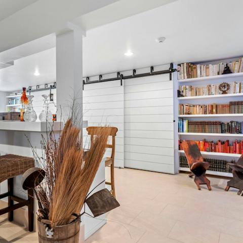 Grab a drink from the bar or a book from the library in the home's 'playroom'