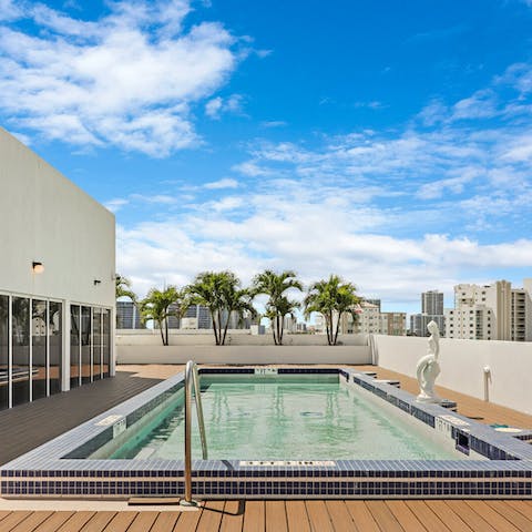 Take a morning dip in the shared rooftop pool