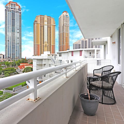 Enjoy cocktail hour on the private balcony, admiring the skyline views