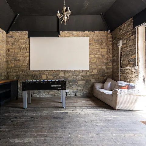 Let the kids hang out in the coach house turned cinema and games room