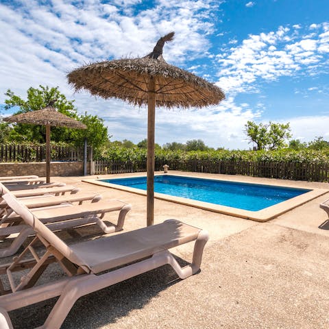 Stretch out poolside under the shade of your parasol