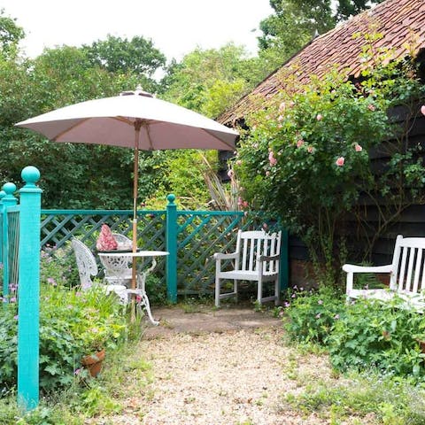 Enjoy a glass of Suffolk wine on the patio surrounded by rambling roses