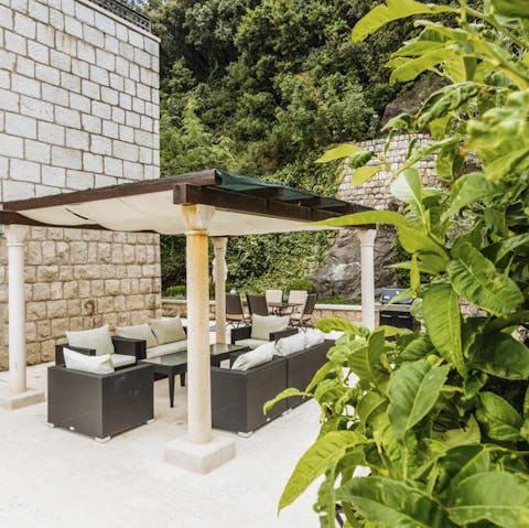 Chill out on the covered terrace and enjoy homecooked meals made in the outdoor kitchen