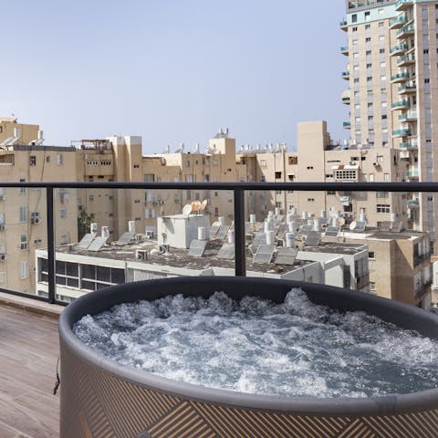 Unwind in the hot tub with a glass of something sparkling in hand