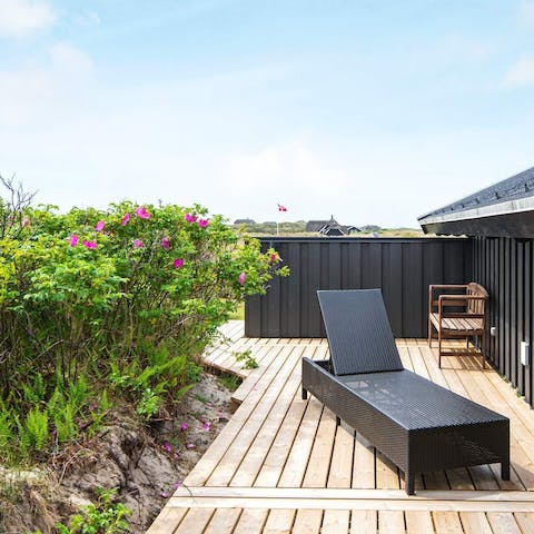 Relax on a sun-lounger on the outdoor deck