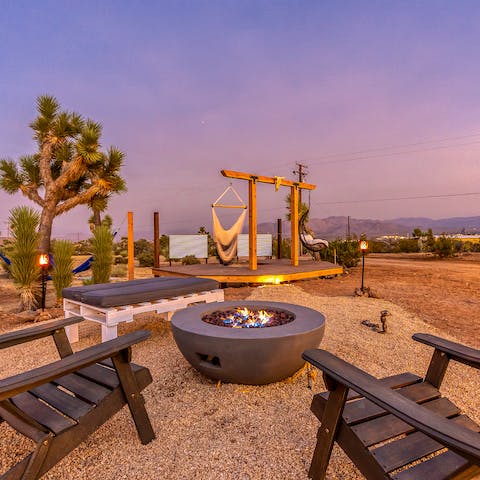 Enjoy a drink around the fire pit as the sun sets